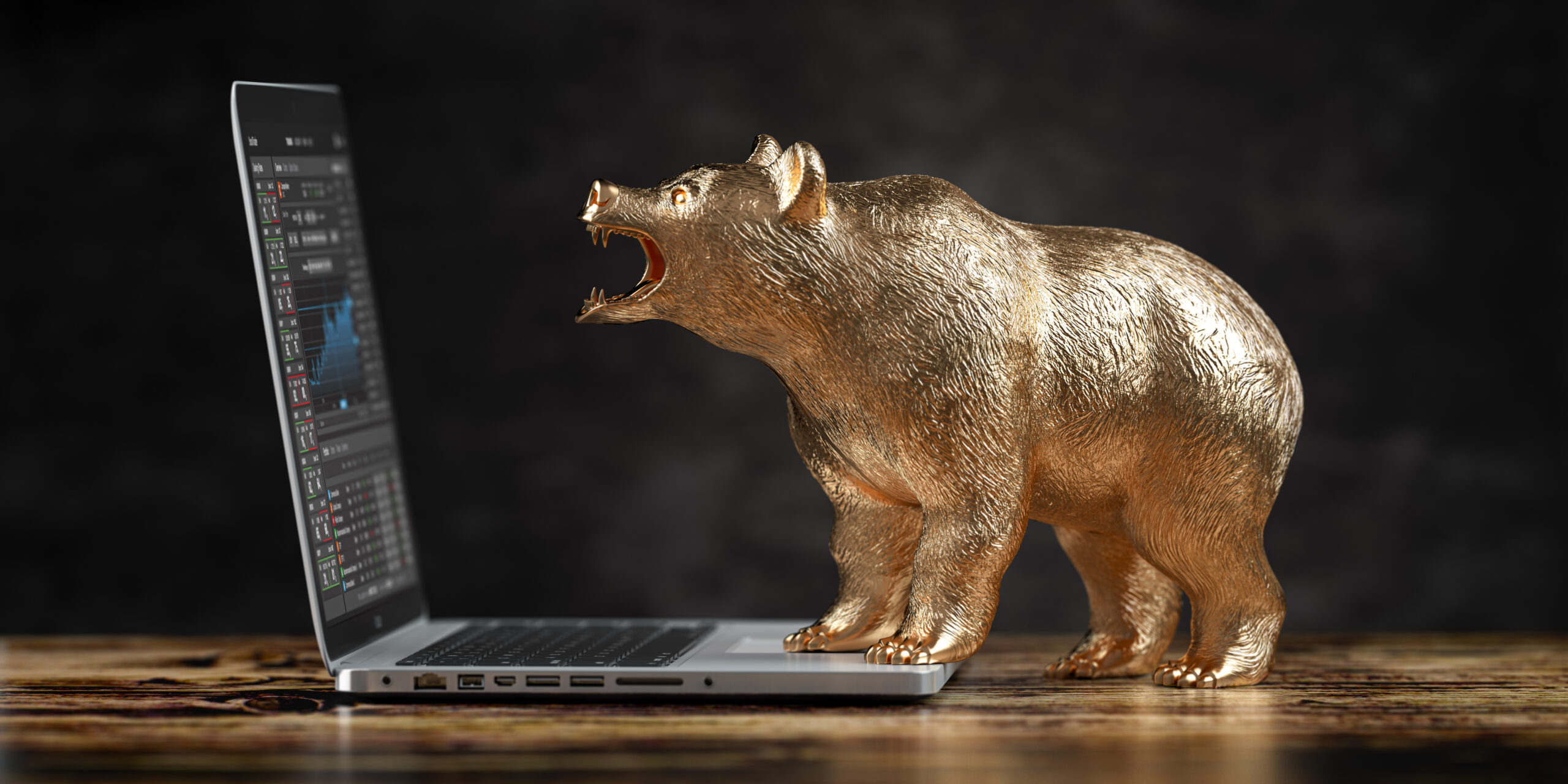 bear and laptop with stock exchange chart on the screen. bearish