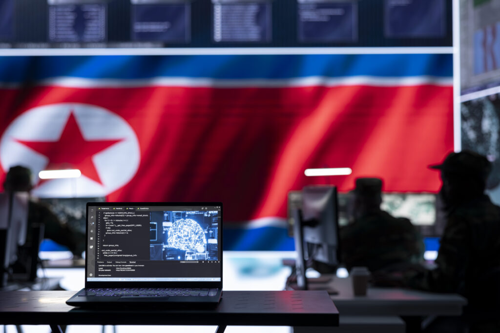 military personnel working in a command post with a north korea flag