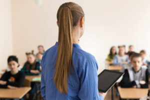 teacher asking her students a question at the elementary school