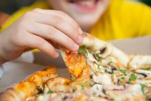 closeup photography of child eating slice of pizza 2025 01 08 20 40 21 utc