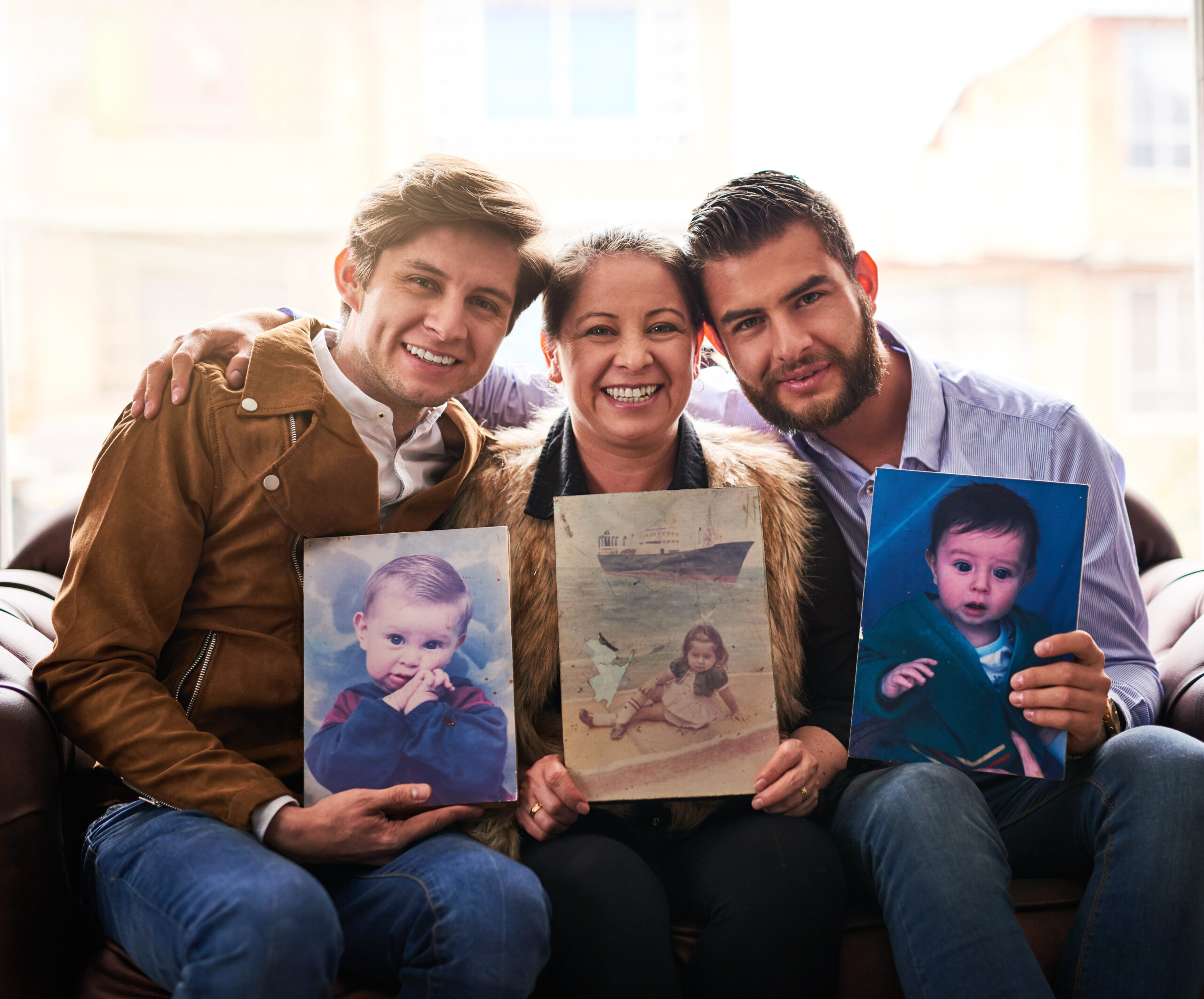 shot of a mother and sons holding old photographs 2025 04 06 08 07 32 utc