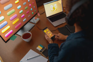 woman graphic designer is using smartphone during work day in home office