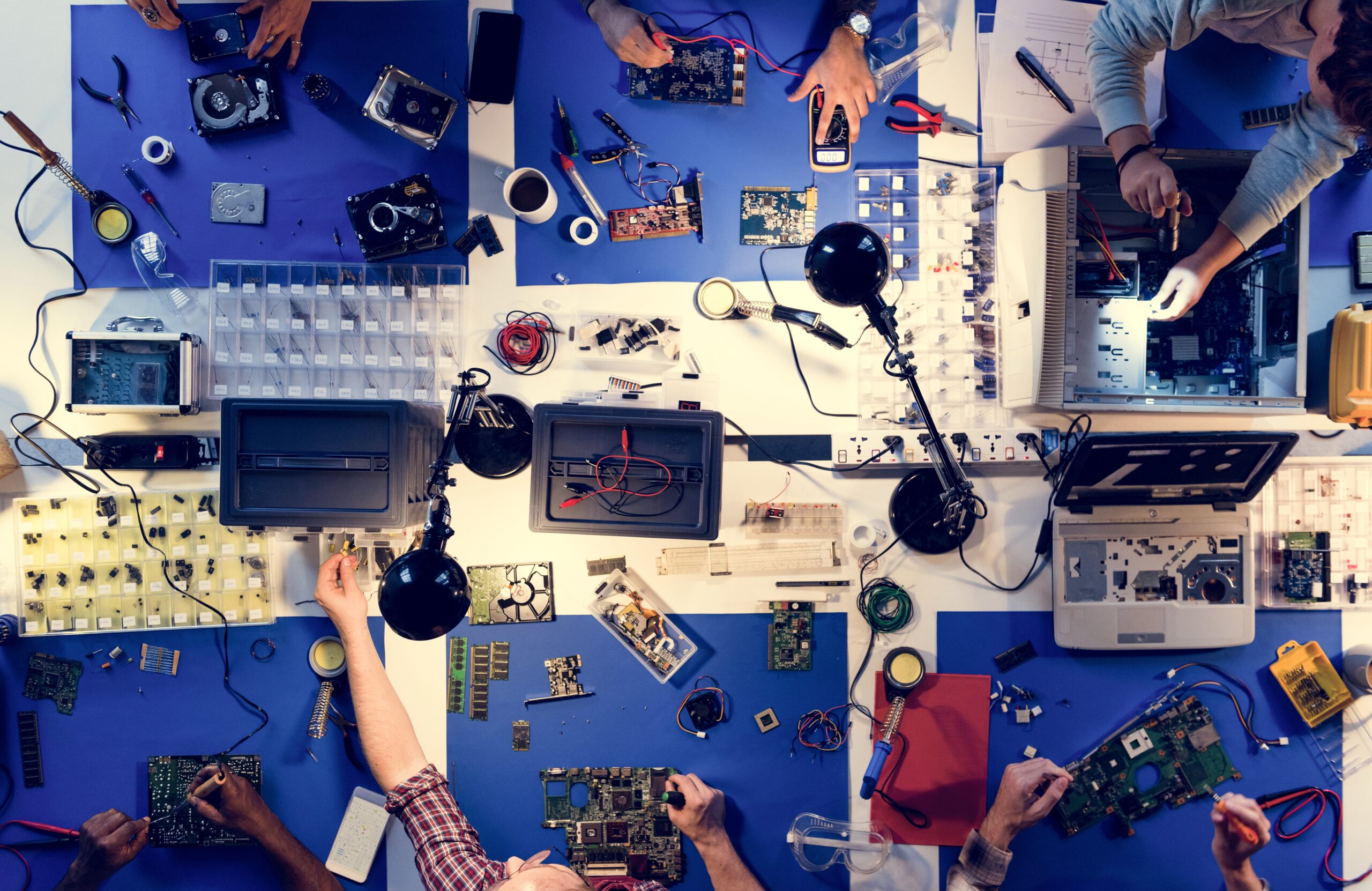 aerial view of electronics technicians team working on computer parts
