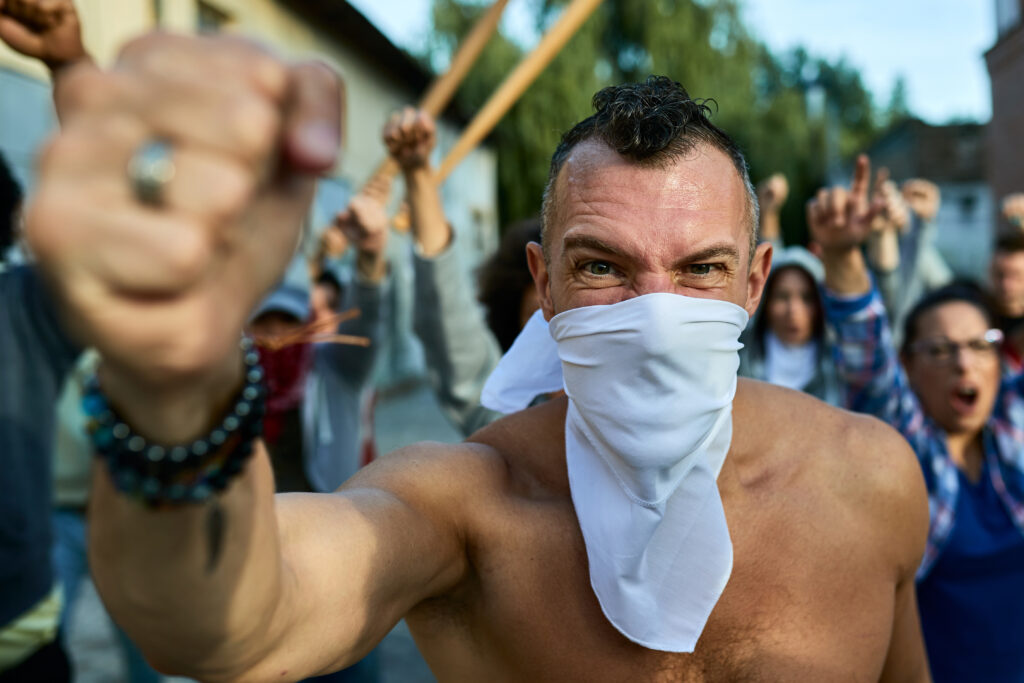 furious man with clenched fist participating in public demonstrations.