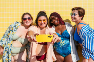 group of plus size women with swimwear at the beach