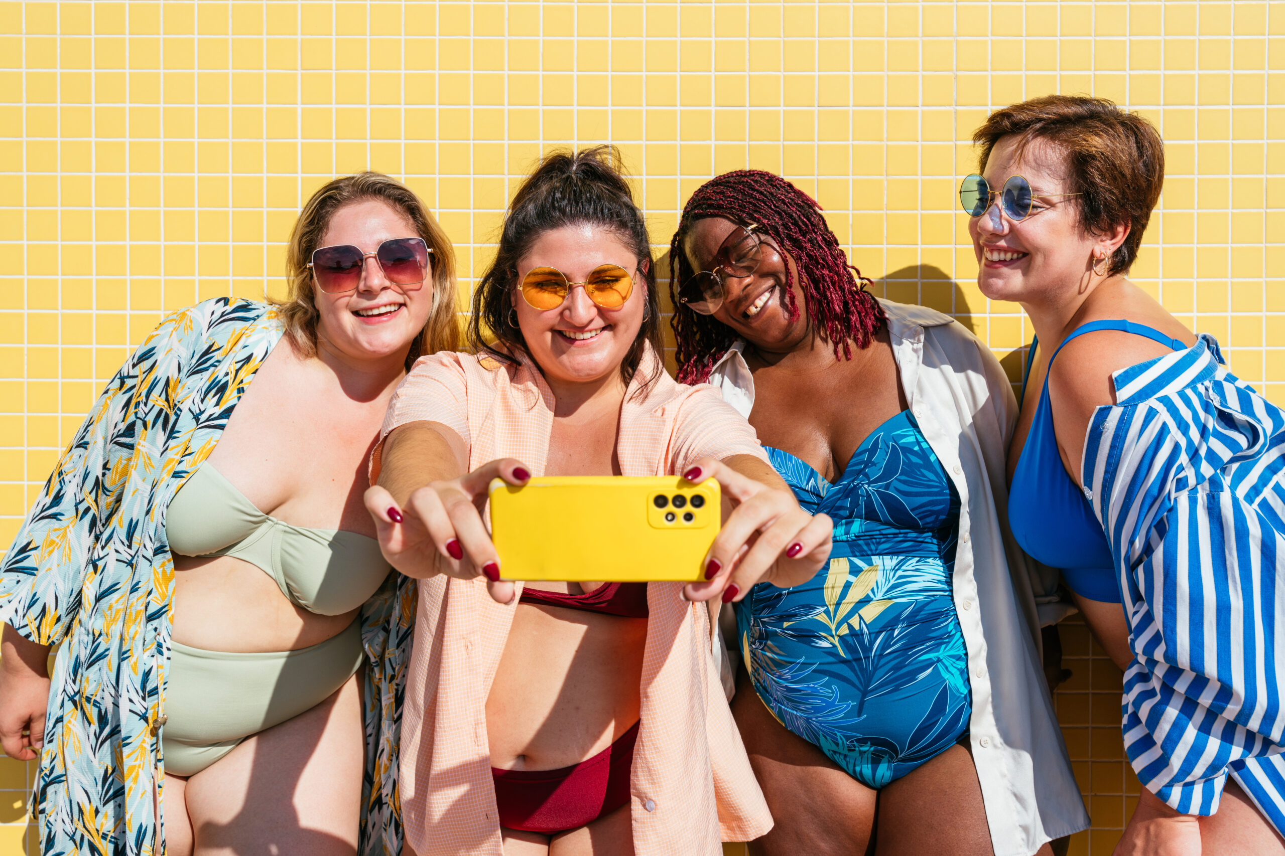group of plus size women with swimwear at the beach