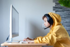 teenage boy in headphones uses computer at home at 2024 12 06 15 40 54 utc