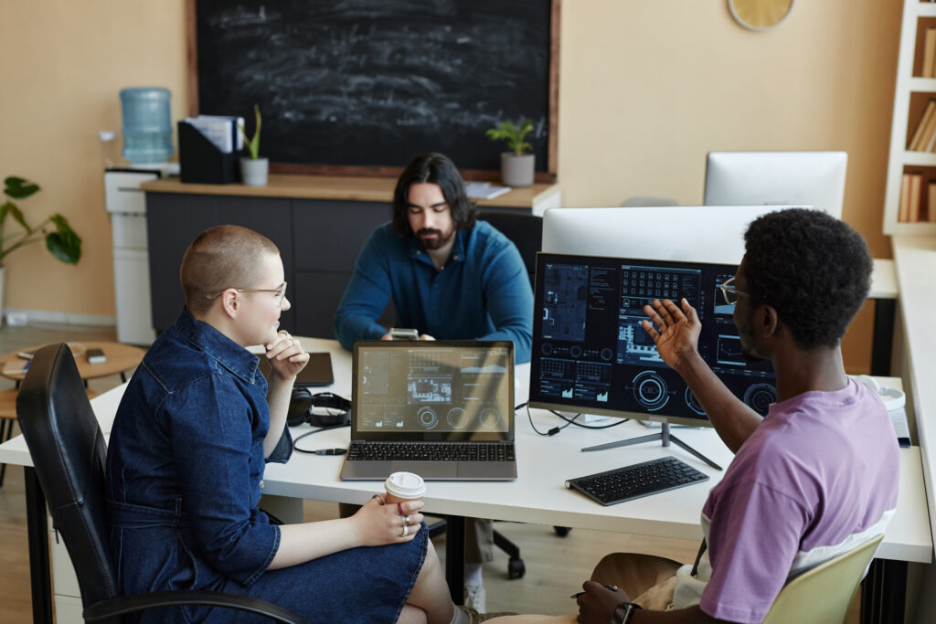 young african american male it engineer explaining something to female colleague