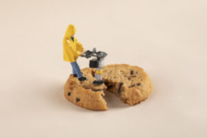 closeup shot of mini construction worker figurines working on a cookie