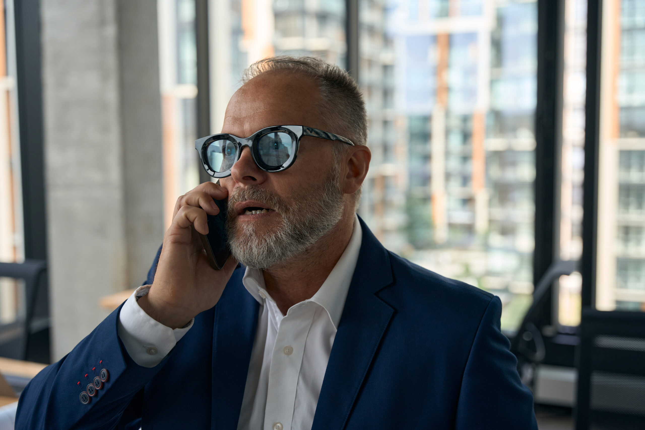 hard working entrepreneur receiving a phone call on his smartphone