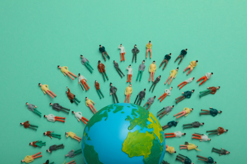 concept of population with globe and toy people