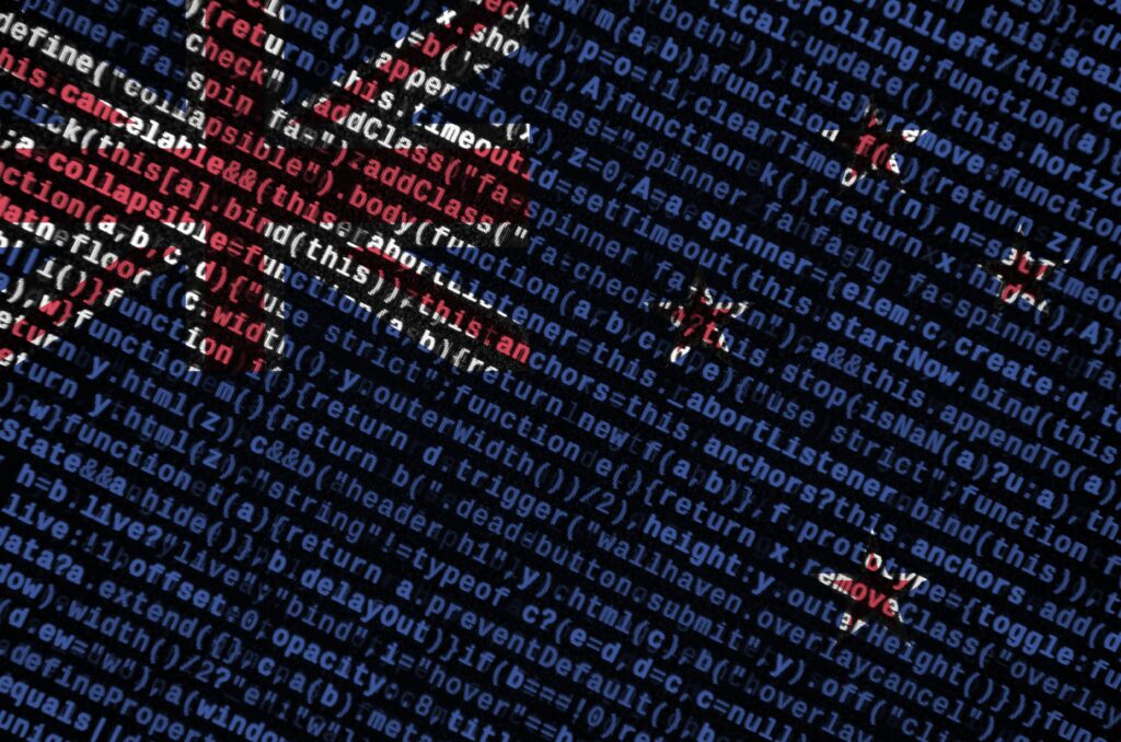 new zealand flag is depicted on the screen with the program code. the concept of modern technology and site development