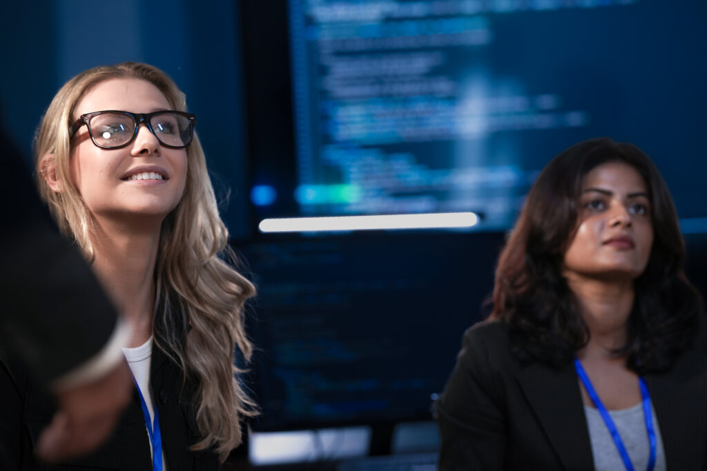 an indian businesswoman and her caucasian colleague with glasses