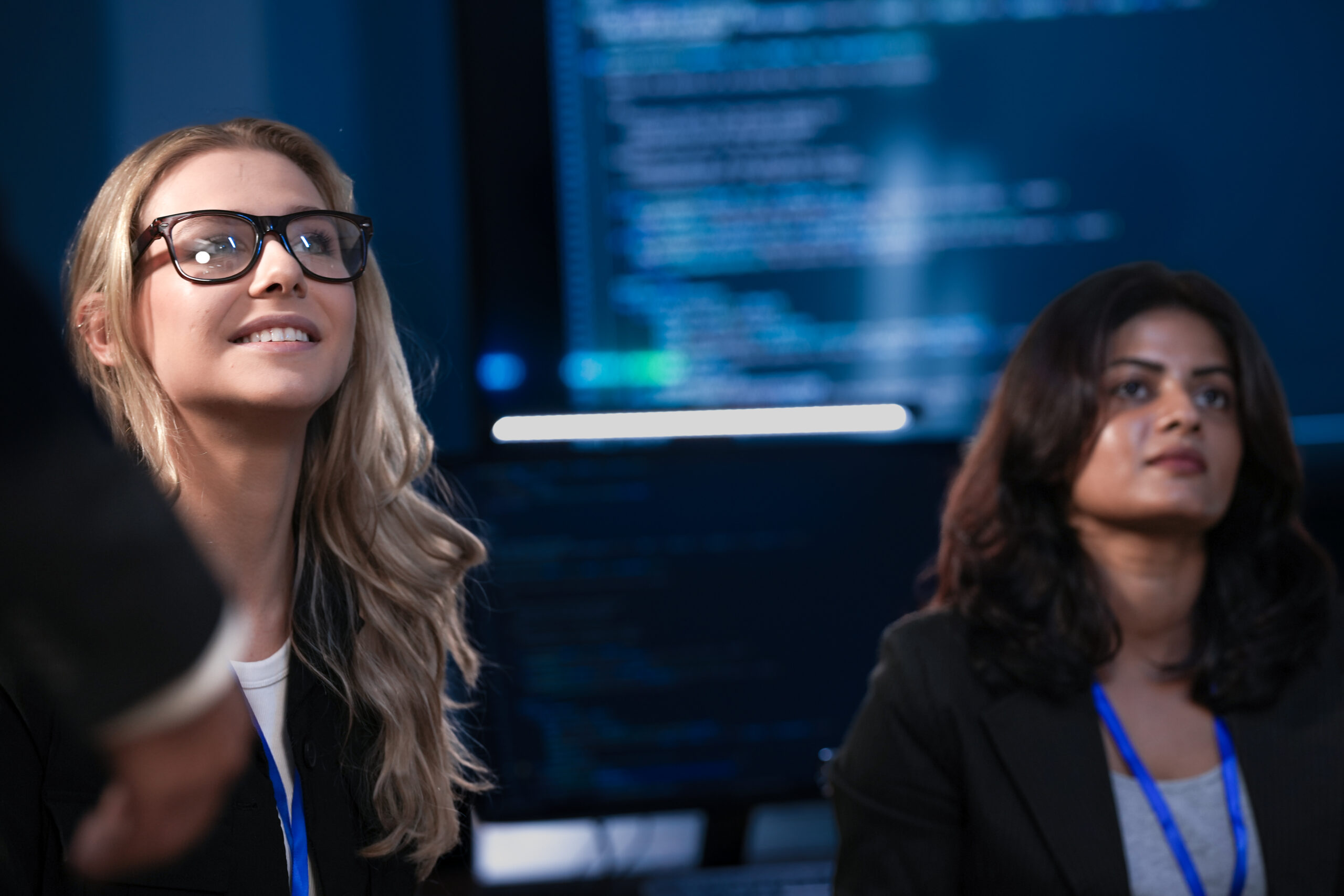 an indian businesswoman and her caucasian colleague with glasses