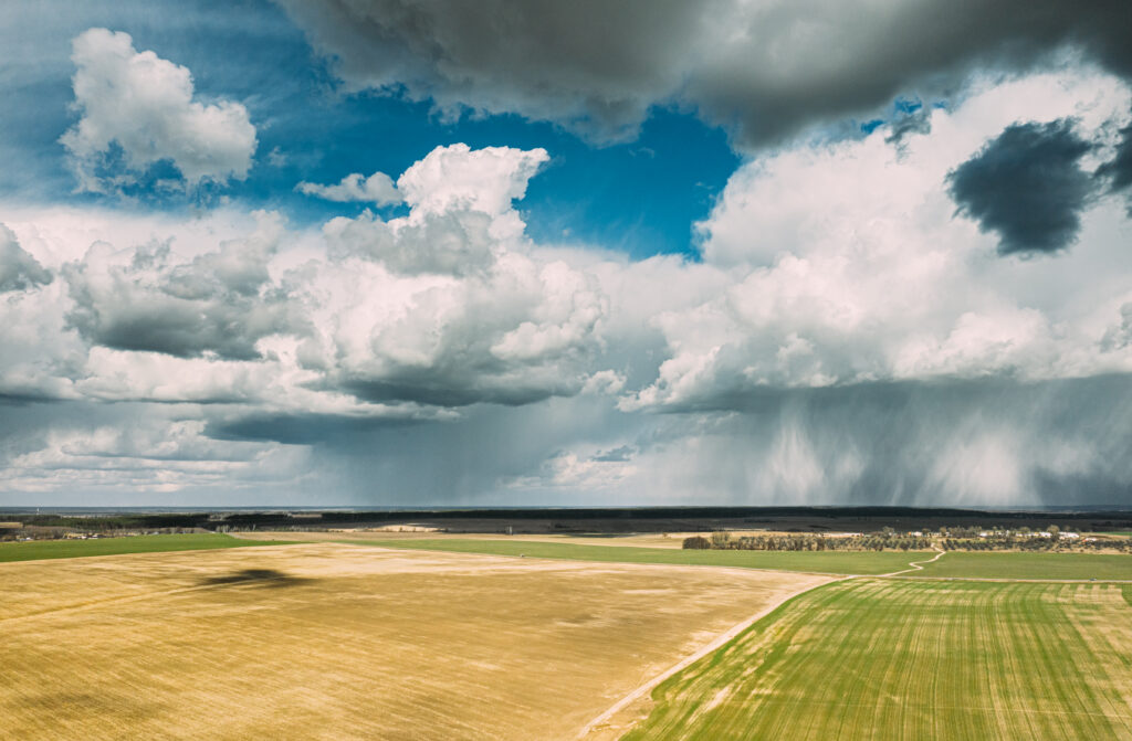 aerial view. amazing natural dramatic sky with rain clouds above countryside rural field landscape in spring summer cloudy day. scenic sky with fluffy clouds on horizon. beauty in nature