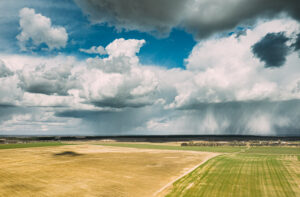 aerial view. amazing natural dramatic sky with rain clouds above countryside rural field landscape in spring summer cloudy day. scenic sky with fluffy clouds on horizon. beauty in nature
