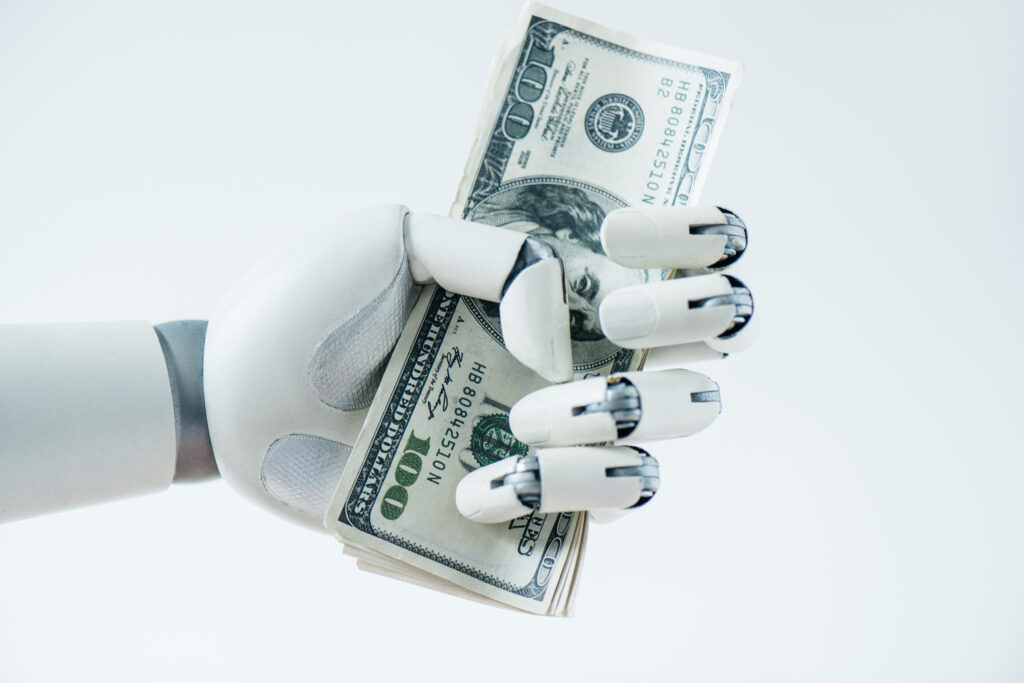 close up view of robot holding dollar banknotes isolated on white