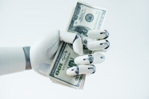 close up view of robot holding dollar banknotes isolated on white