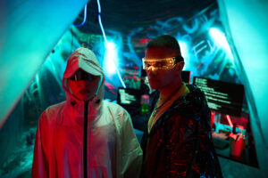 young multiethnic hackers wearing futuristic glasses operating computers indoors