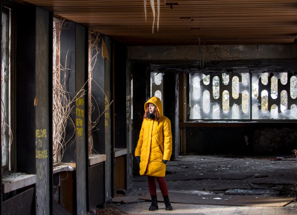 young woman in yellow winter jacket looking throug 2026 01 07 06 12 37 utc