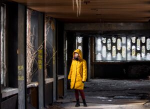 young woman in yellow winter jacket looking throug 2026 01 07 06 12 37 utc