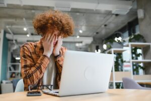 caucasian hipster guy enjoying distance job in coffee shop, male freelancer in trendy glasses sitting in cafeteria with modern laptop device
