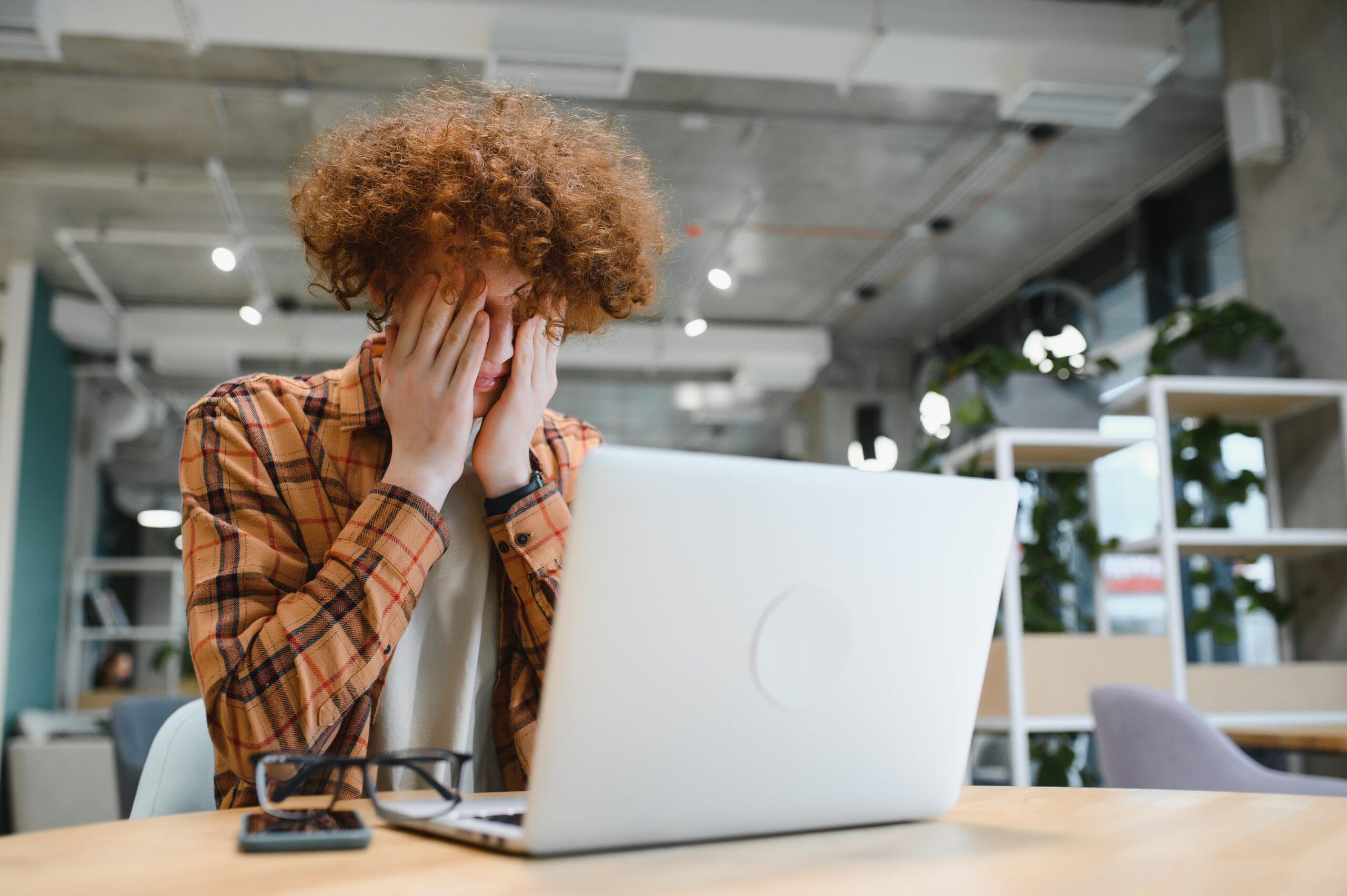 caucasian hipster guy enjoying distance job in coffee shop, male freelancer in trendy glasses sitting in cafeteria with modern laptop device
