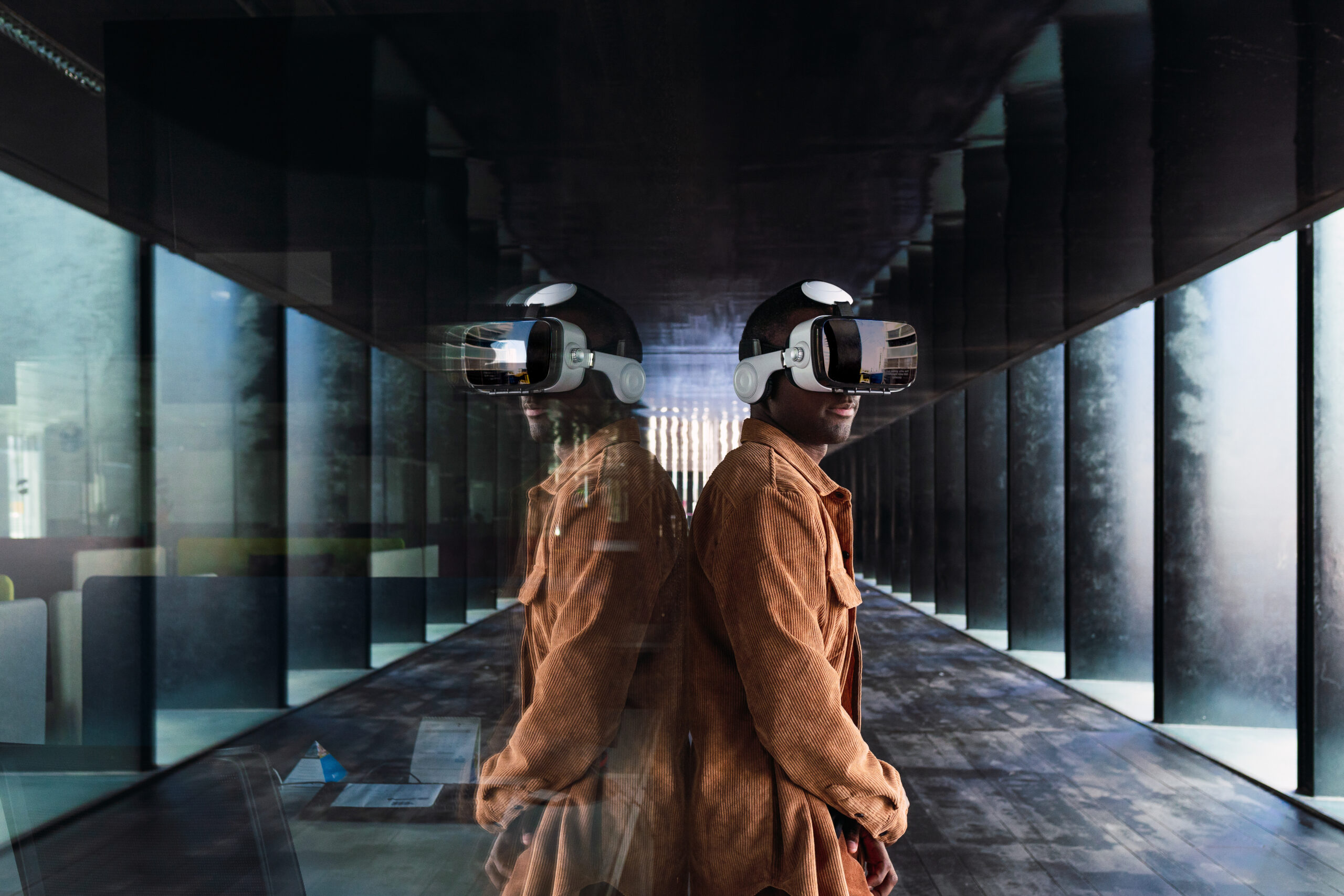 black man exploring cyberspace near glass wall